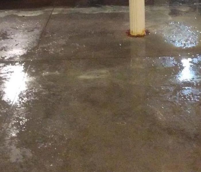 Concrete floor with puddles and wet areas all over it